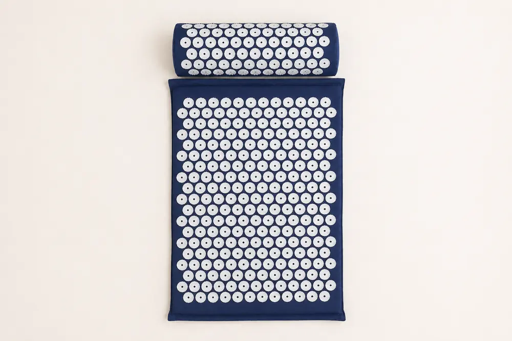 SpikeRest acupressure mat and bolster pillow set in Navy Blue on a plain backdrop